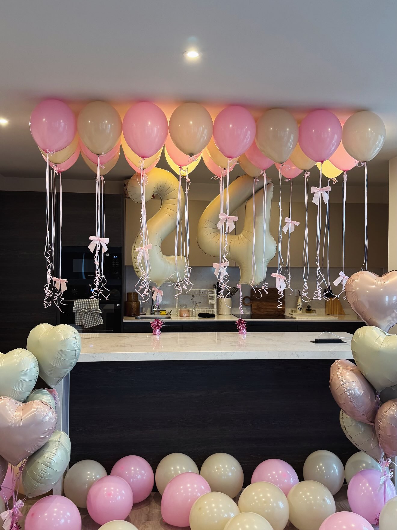 Full room view of a pink and ivory 24th birthday setup